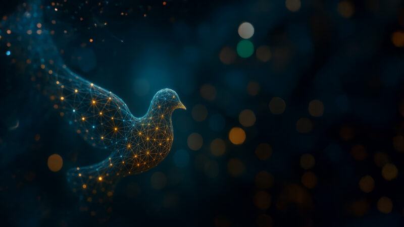 A photorealistic digital artwork of a dove composed of glowing neural connections and data nodes, illuminated in soft blue and amber tones. The bird, symbolising digital peace and interconnectedness, appears to emerge from a network of light against a dark, blurred background with warm bokeh highlights.