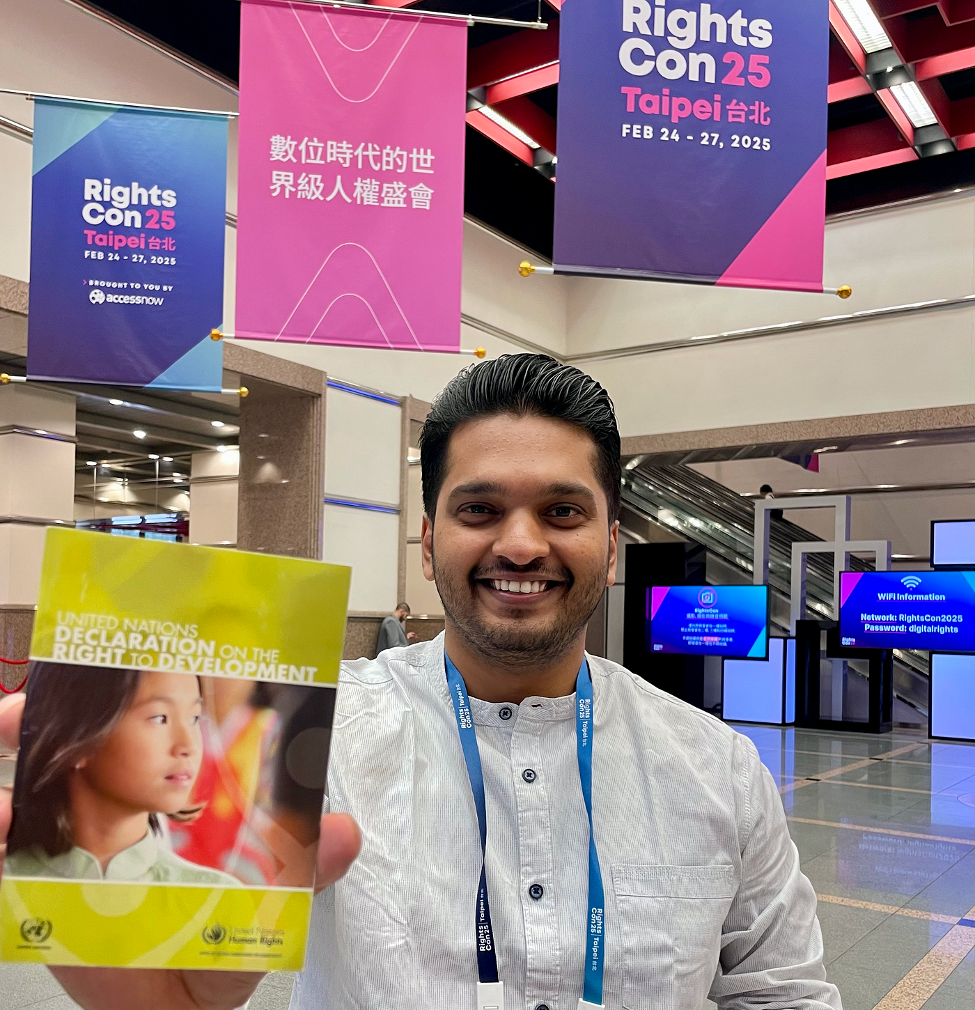 Author Irfan Pullani with the UN Declaration on Right to Development at RightsCon 2025