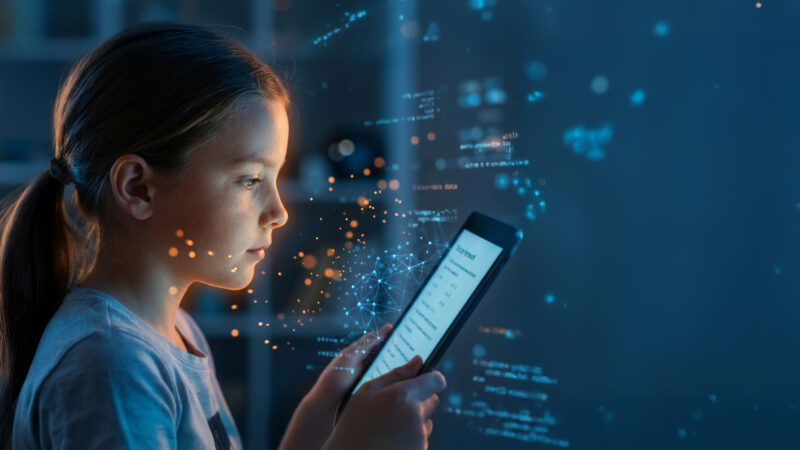 Child reading on a tablet with digital elements, illustrating education in the age of AI.