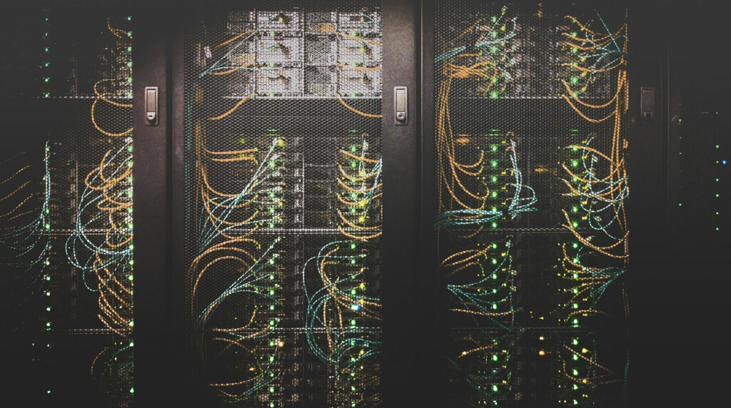 Close-up view of an organized cable network inside a data center showing bundled network cables and infrastructure