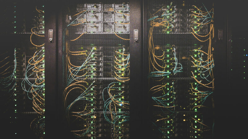 Close-up view of an organized cable network inside a data center showing bundled network cables and infrastructure