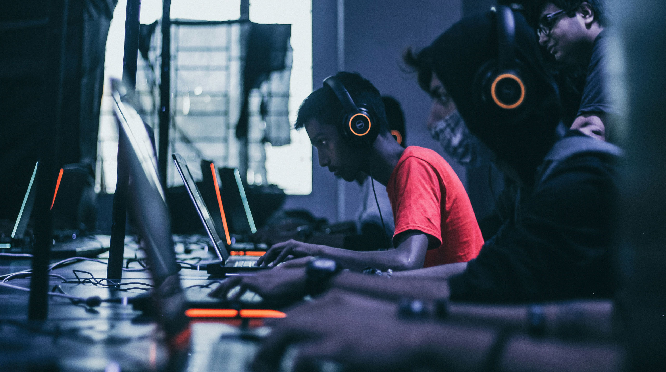 Effects of AI on young people illustrated by teenagers using computers and digital technology in a classroom